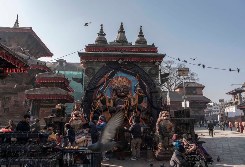 Worshippers light diyas, or oil lamps, at the Kaal Bhairav Hindu shrine in Kathmandu Durbar Square in Nepal’s capital