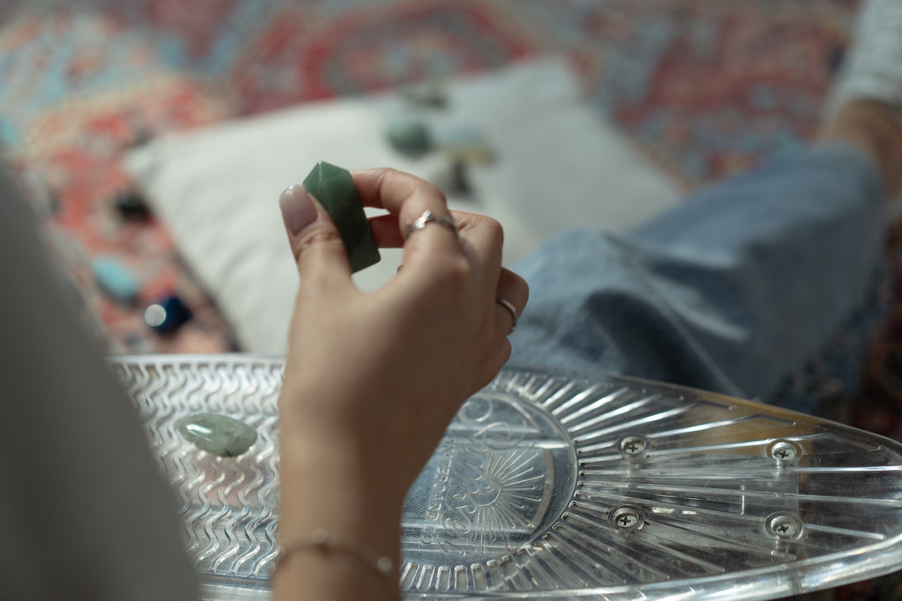 A Person Holding a Green Gemstone
