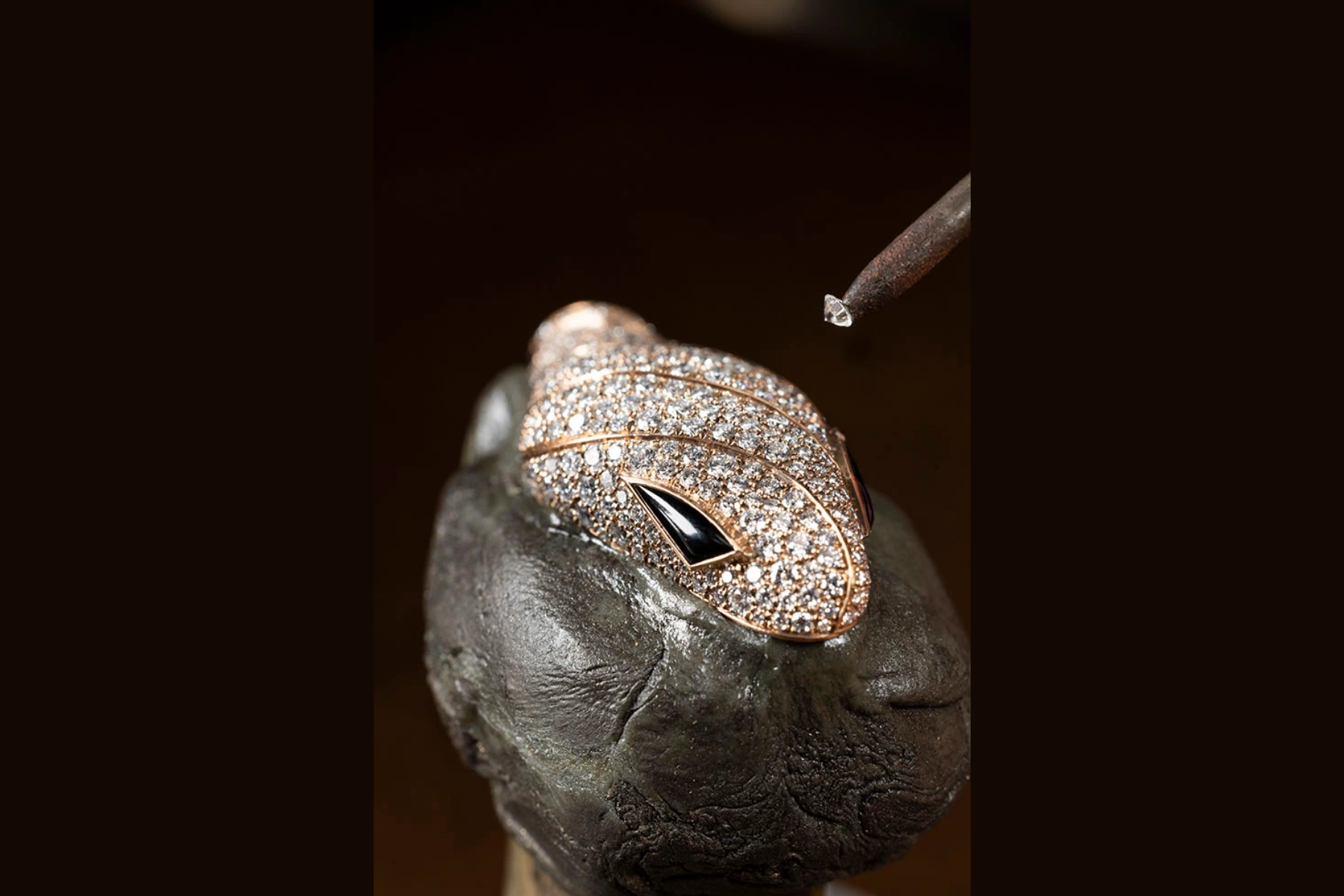 A jewelry maker at the Bulgari workshop adds a diamond to the head of a snake in the house’s Serpenti collection