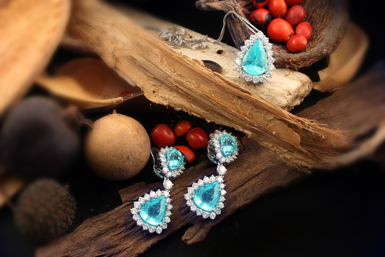 Matching blue tear-shaped tourmaline necklace and drop earrings surrounded by small white round tourmalines