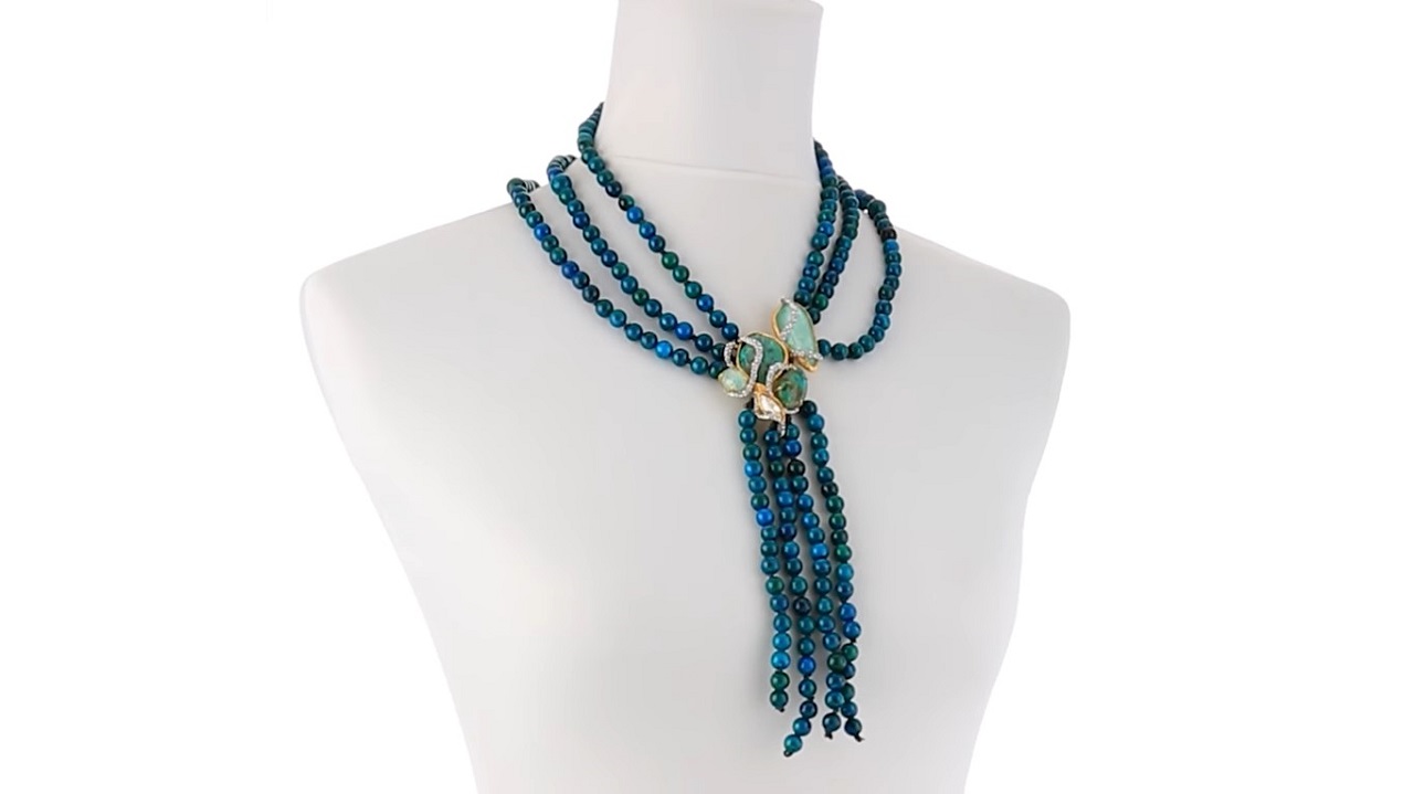 A three-layered blue-green bead-like chrysocolla necklace fastened by amazonite crystals in the middle