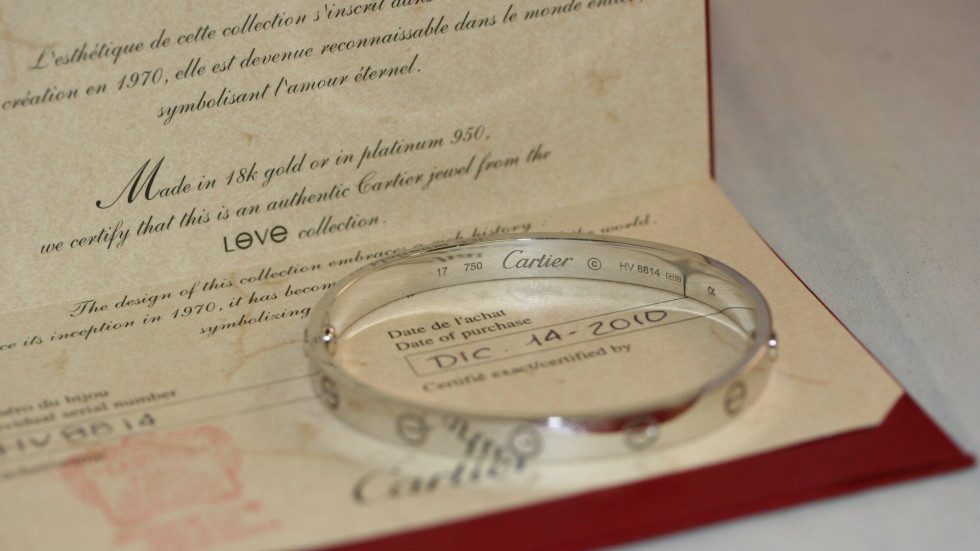 Cartier Love bracelet resting on authenticity certificate
