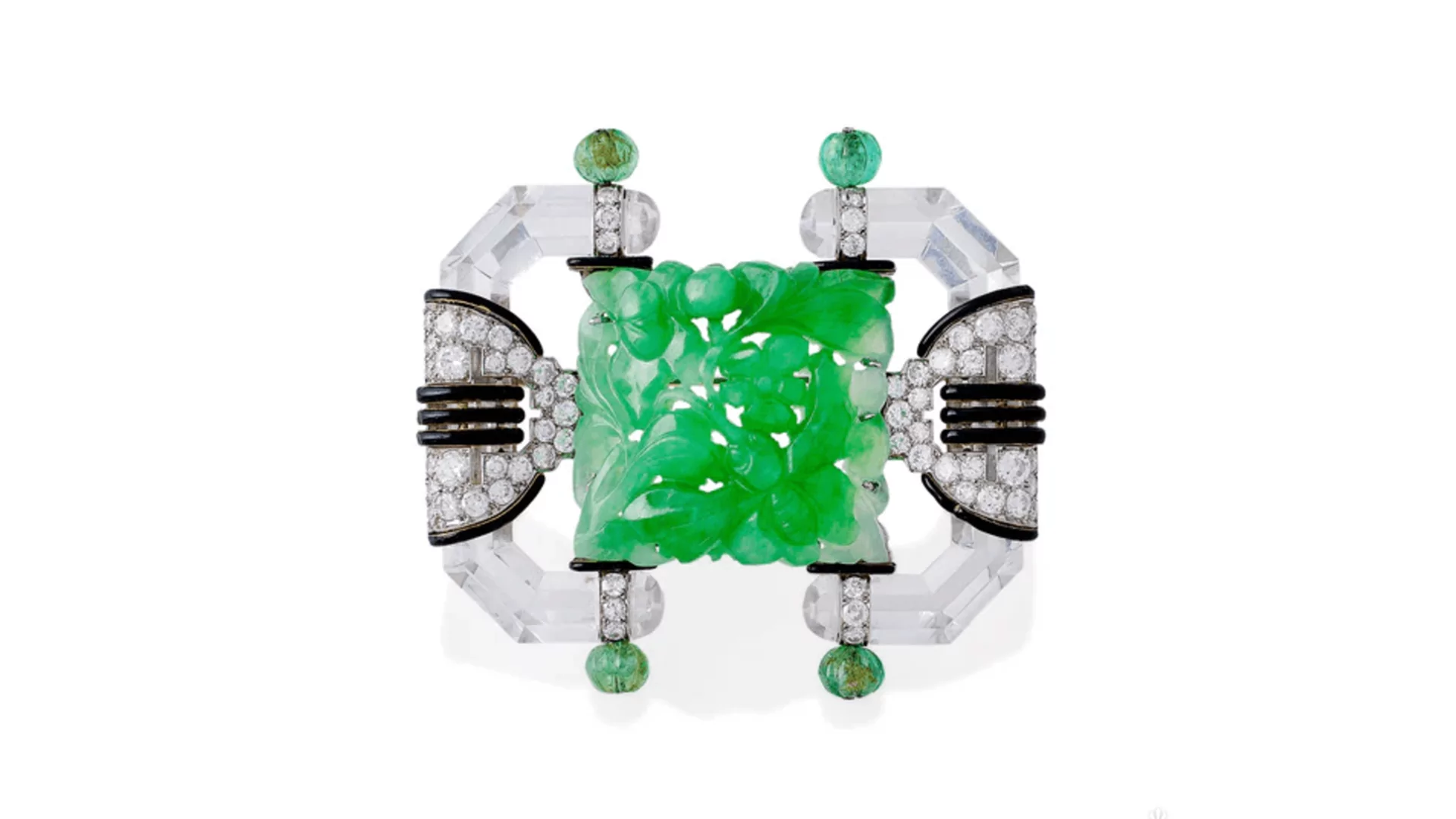 Carved emerald centerpiece with diamond and crystal setting